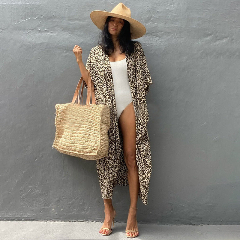 Yellow-toned leopard-print cover-up worn over a white swimsuit.