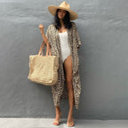 Yellow-toned leopard-print cover-up worn over a white swimsuit.