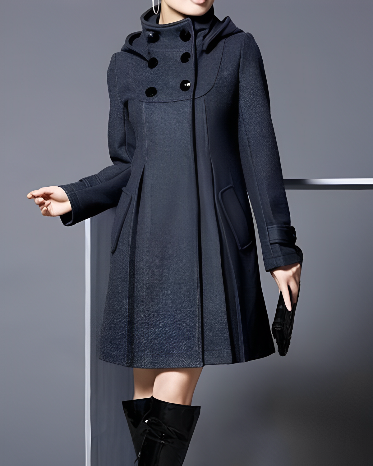 Dark coat with two rows of upper buttons, cuff tabs and a flared hem.