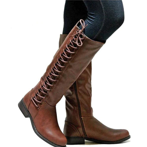 Dark brown tall lace-up boots shown being worn.