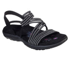 Black sandal with crossed striped straps and an open toe.