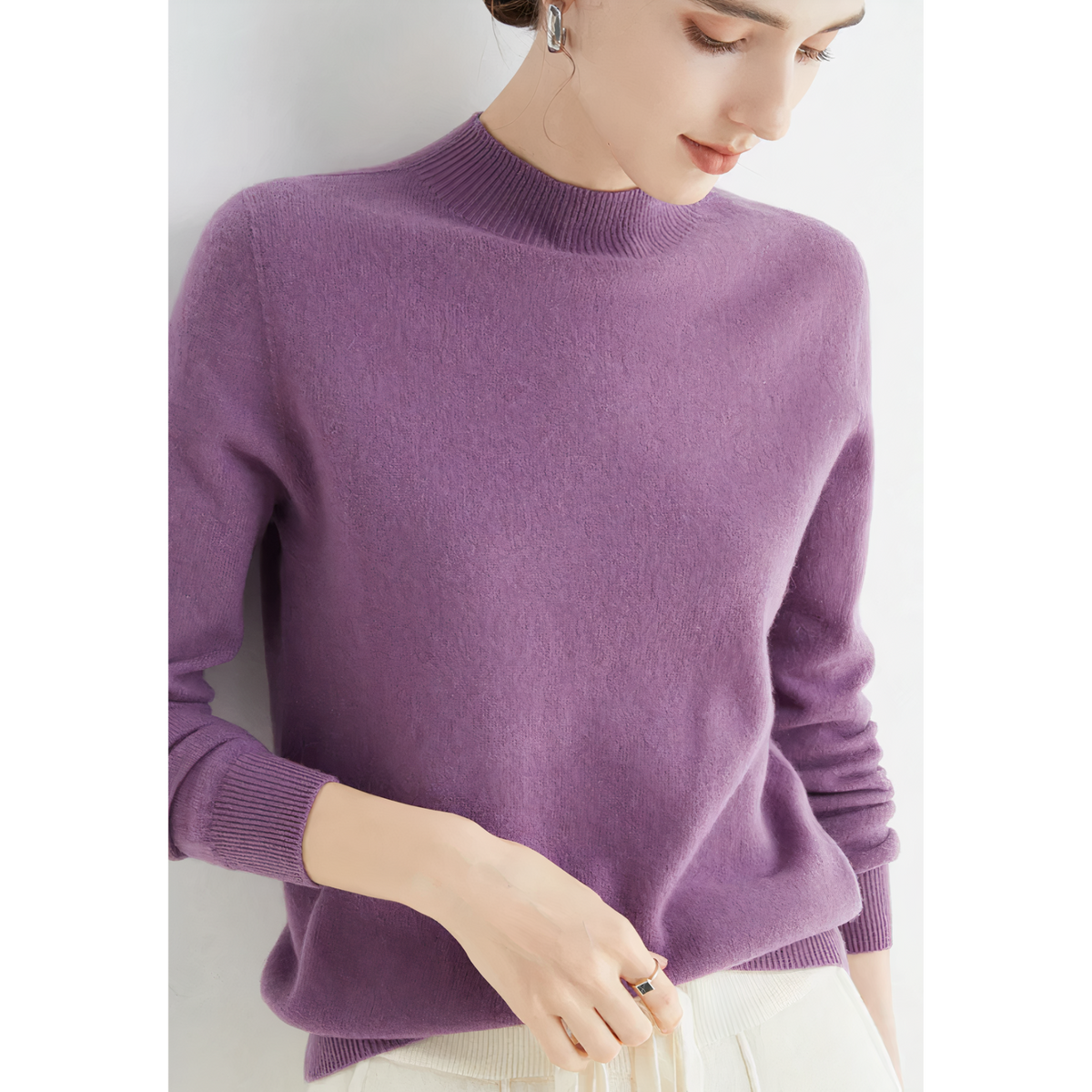 Purple jumper with a high neckline and long sleeves.