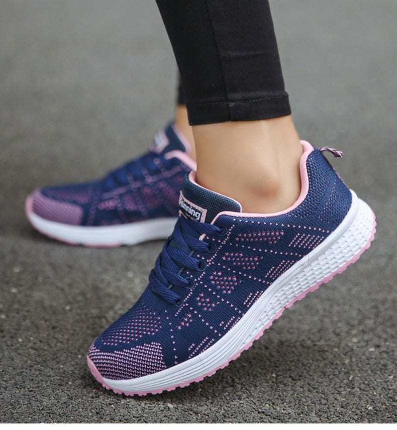 Blue trainers with pink edging and white textured soles.