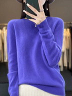 Purple jumper with a rounded neck and ribbed hem.