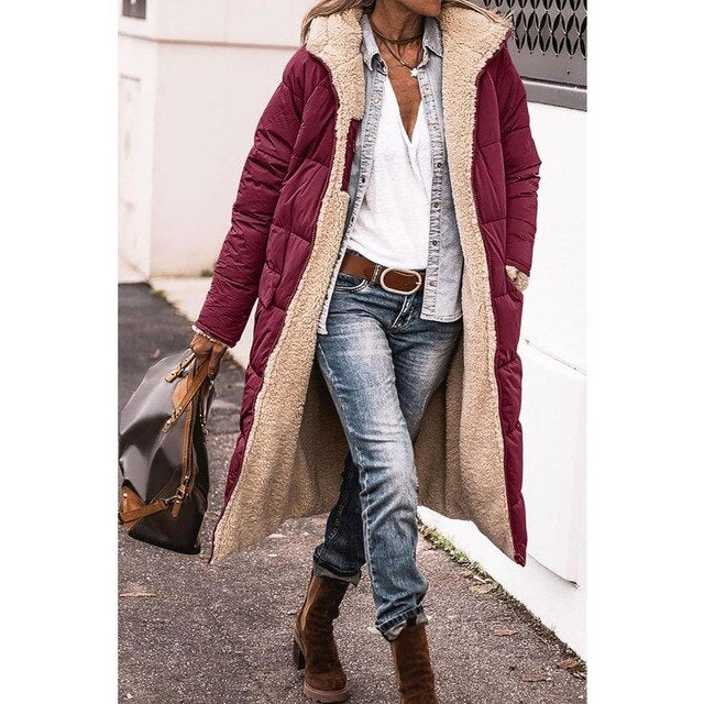 Burgundy long jacket with a hood and quilted sleeves.