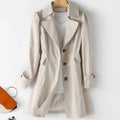 Beige trench-style jacket with three front buttons, broad lapels and tabbed cuffs on a hanger.