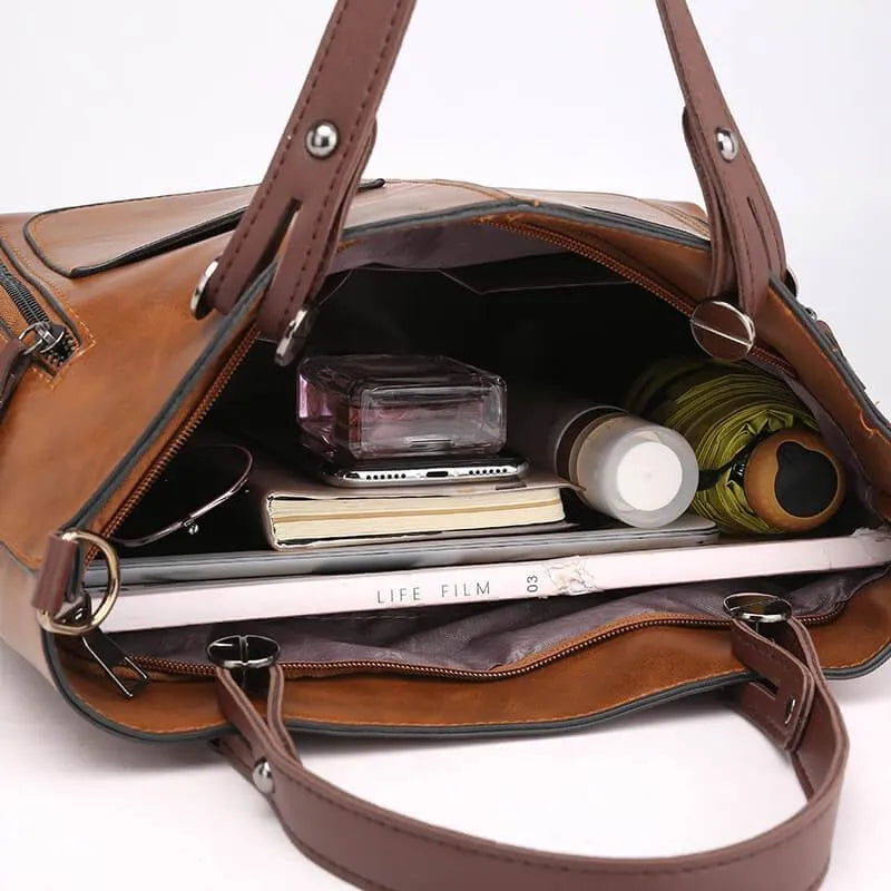 Open handbag showing the lining and items inside.