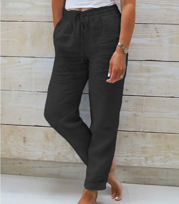 Black relaxed trousers with a gathered drawstring waist.