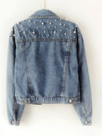 Rear view of a denim jacket with pearl-style beads across the upper back.