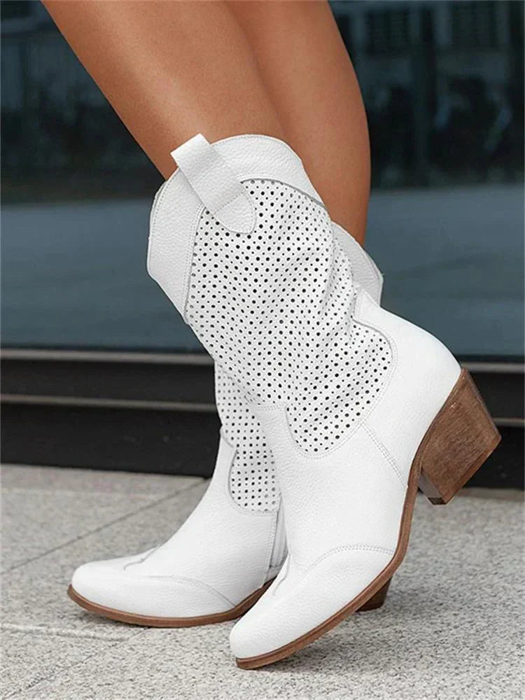 White boots with shaped toe panels and block heels.