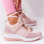 Pink trainers with contrasting toe panels and metallic trim.