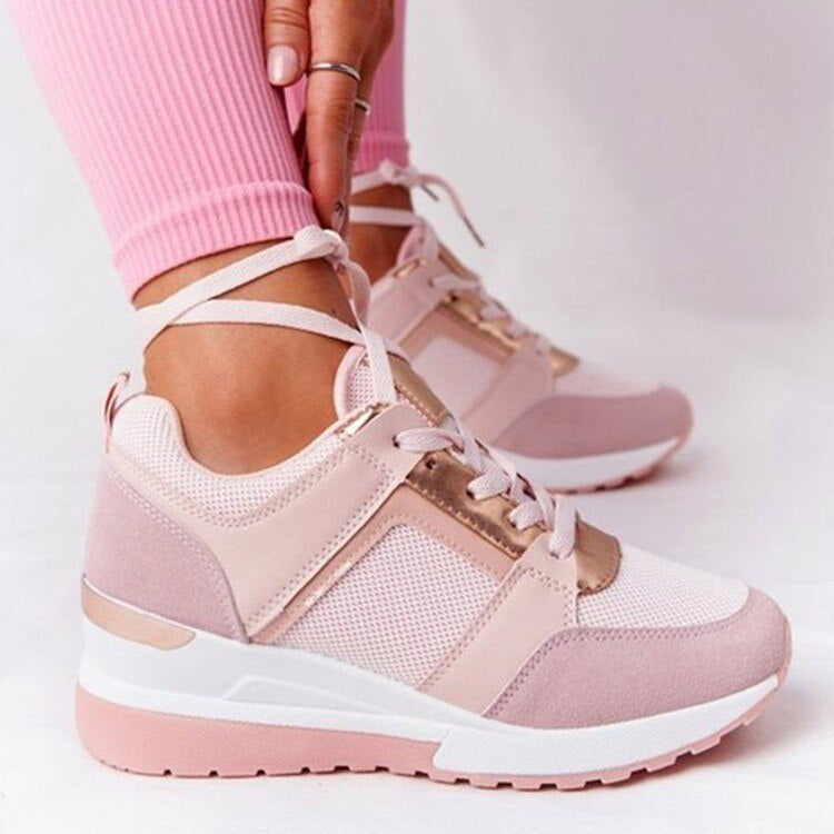 Pink trainers with contrasting toe panels and metallic trim.