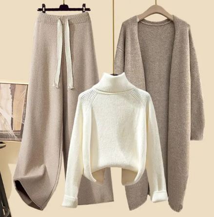 White roll-neck jumper shown with beige trousers and a long beige jacket.
