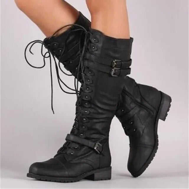 Black tall lace-up boots with two upper buckle straps and one near the ankle.