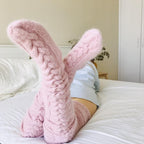 Pink long socks with prominent cable-knit texture.