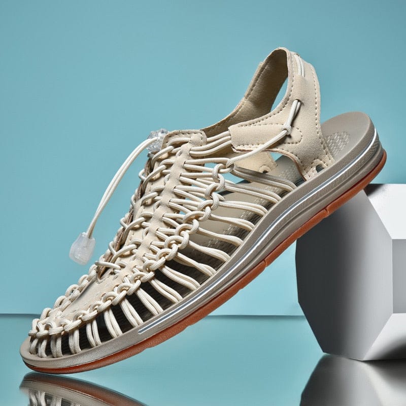 Beige cord sandal with a toggle lace and brown-edged sole.