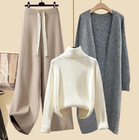 White roll-neck jumper paired with beige trousers and a grey open jacket.
