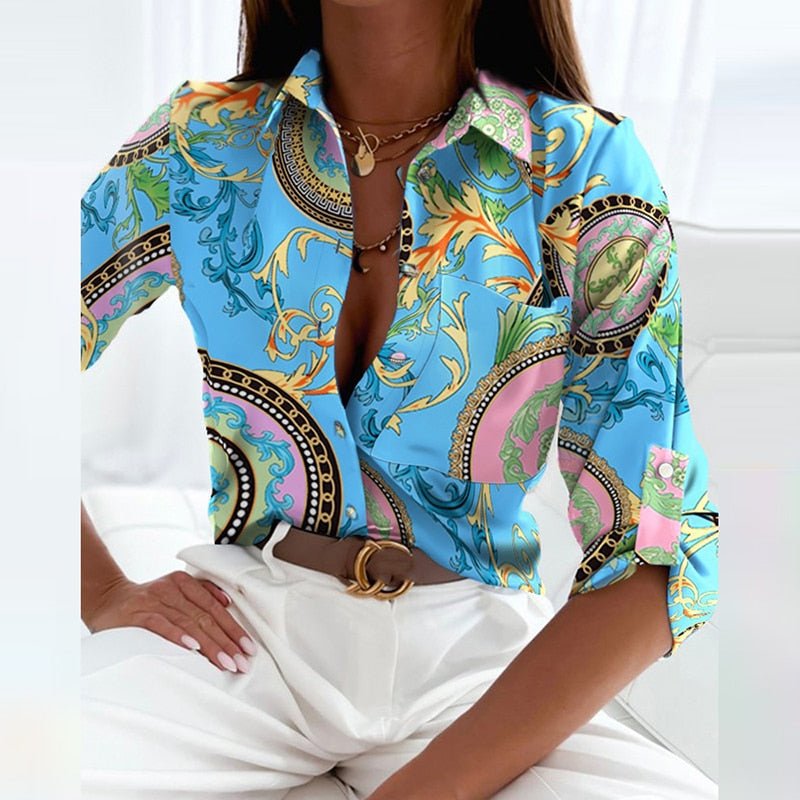 Blue blouse with a multicoloured ornamental print.