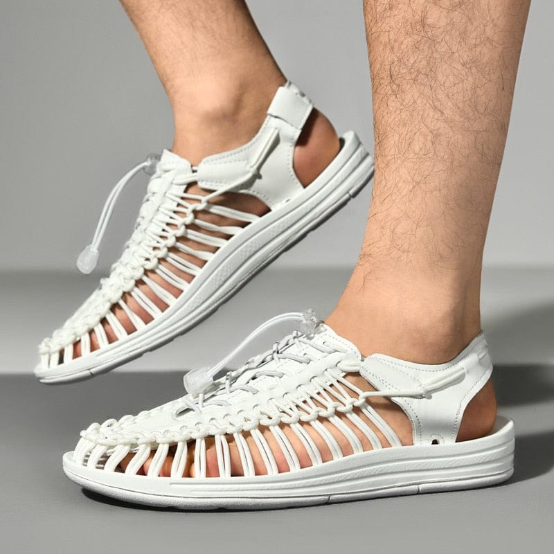 White cord sandals with toggle laces and open slingback heels, worn in side view.