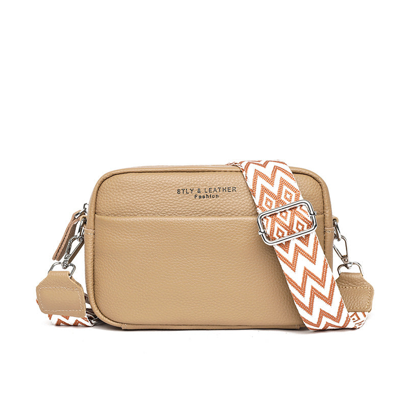 Khaki shoulder bag with a brown-and-white patterned strap.