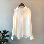 Ice white shirt with a pointed collar, dropped shoulders and long cuffs.