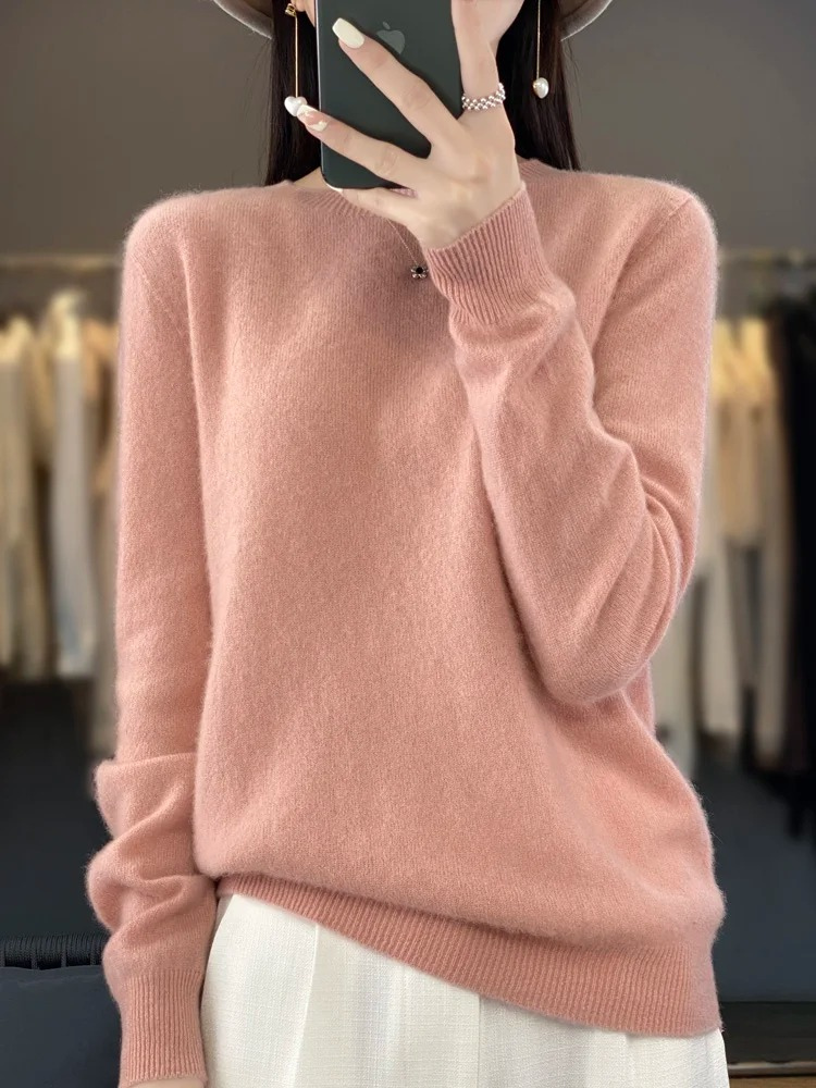 Light pink jumper with a ribbed hem and long sleeves.