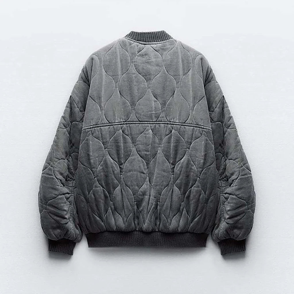 Rear view of the grey bomber jacket with curved quilting.