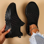 Black trainers shown from above with textured front panels.