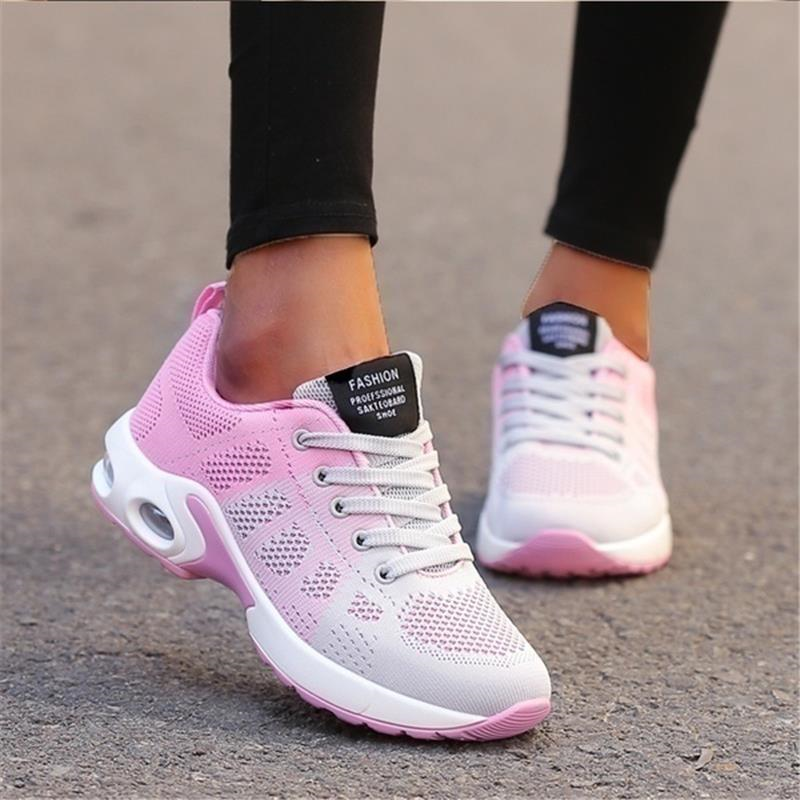 Pink-and-white trainers with pale laces and white soles.