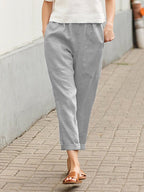 Grey Dayanara trousers worn with rolled hems.