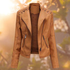 Tan-orange leather-look jacket with a front zip and shoulder lacing.