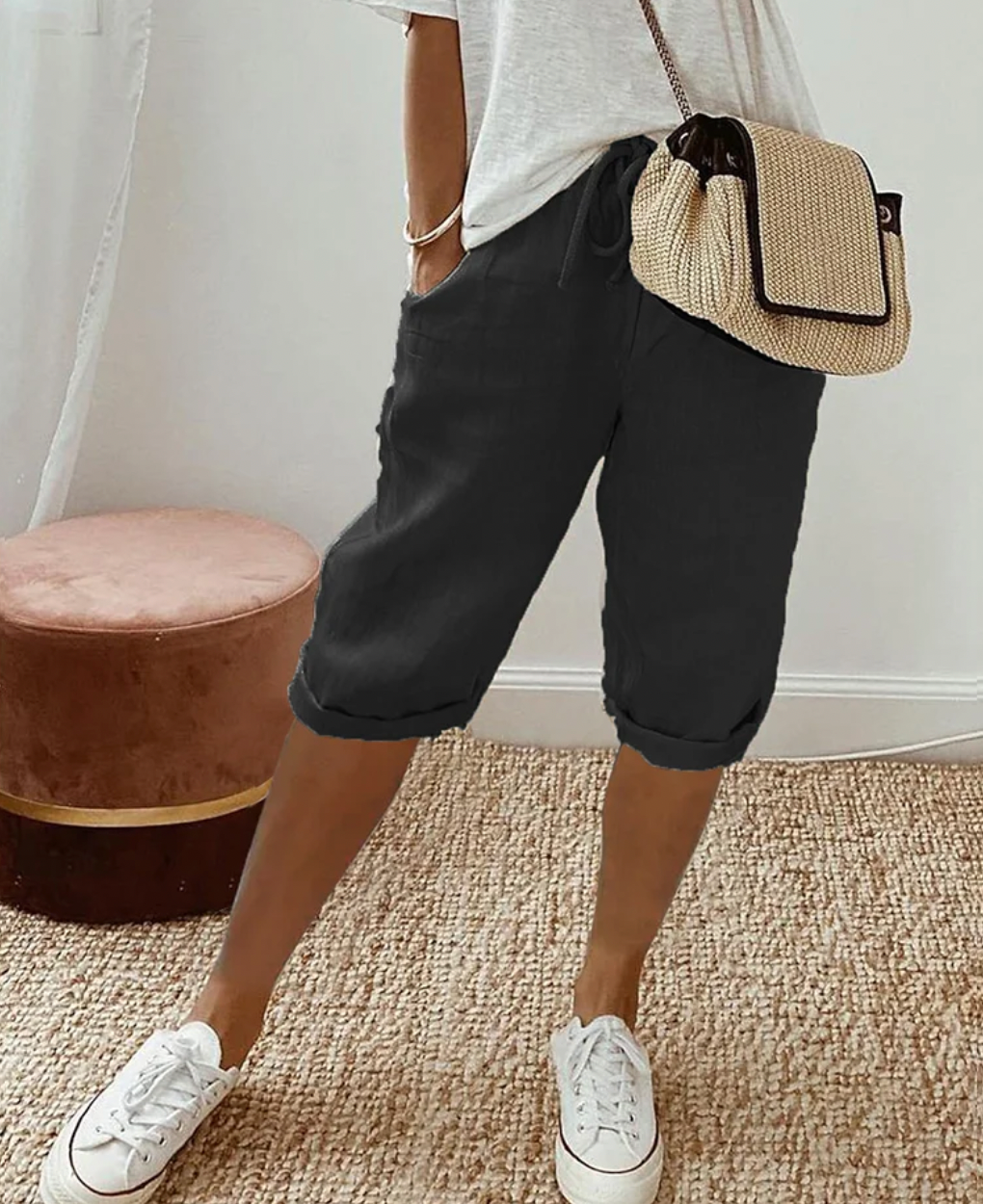 Black knee-length shorts with a front drawstring and side pockets.