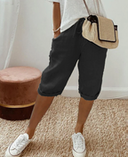 Black knee-length shorts with a front drawstring and side pockets.