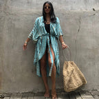 Pale blue patterned cover-up tied over a black swimsuit.