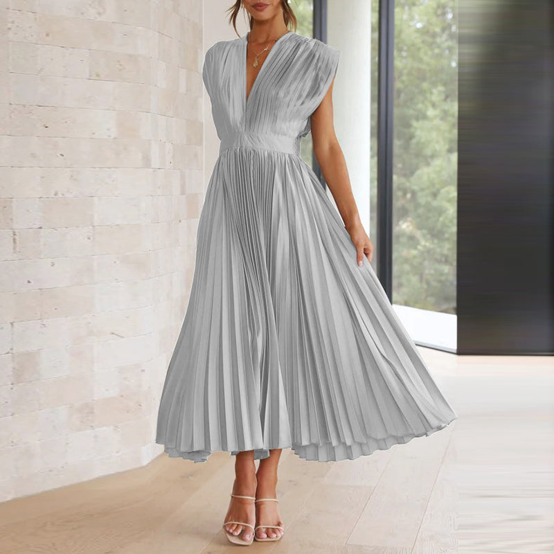 Grey pleated midi dress with a deep V-neck and flowing skirt.
