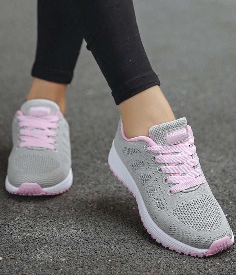 Grey and pink trainers shown from the front.