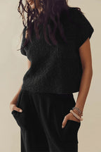 Black short-sleeve knit top and black trousers shown from the front.