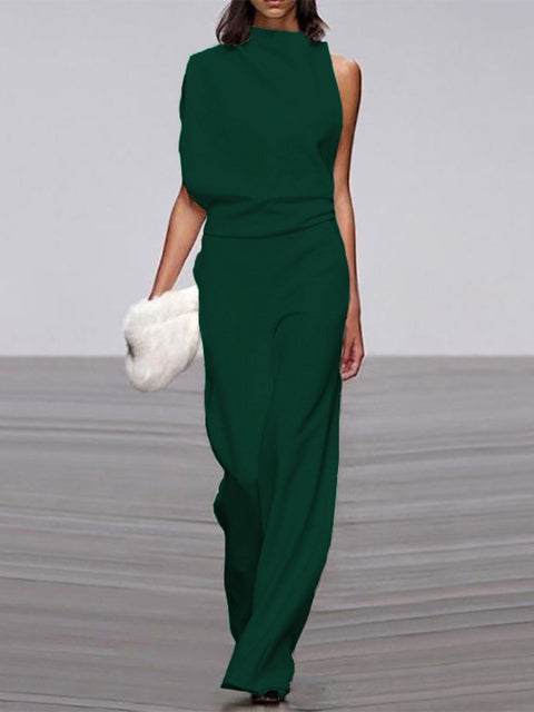 Dark green sleeveless jumpsuit with a draped upper section.