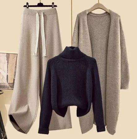 Dark navy jumper displayed beside beige drawstring trousers and a long beige jacket.