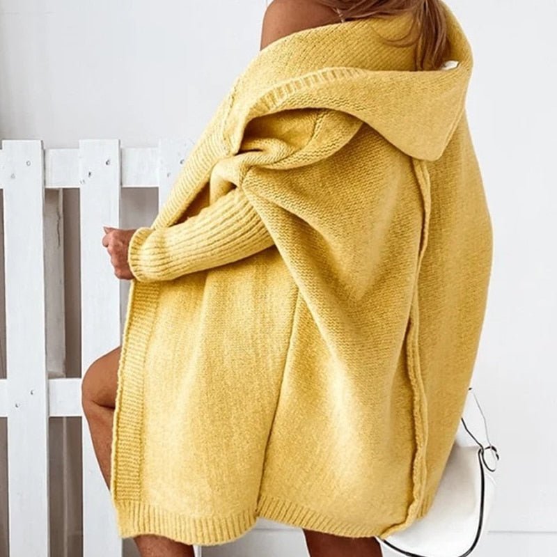 Rear view of the yellow cardigan showing the hood and back seam.