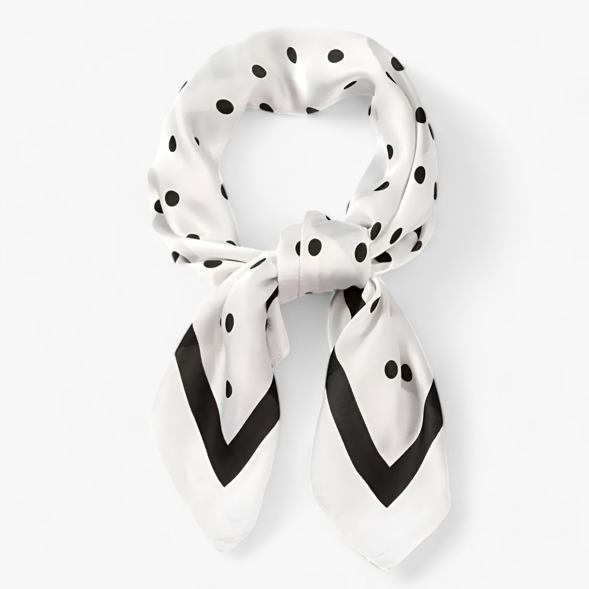 White polka-dot scarf with a dark border tied in a knot.