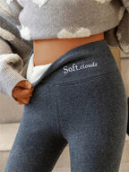 Dark grey leggings with the waistband folded forward to show a pale fluffy lining and original white logo.