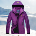 Purple hooded jacket with dark panels and zipped pockets.