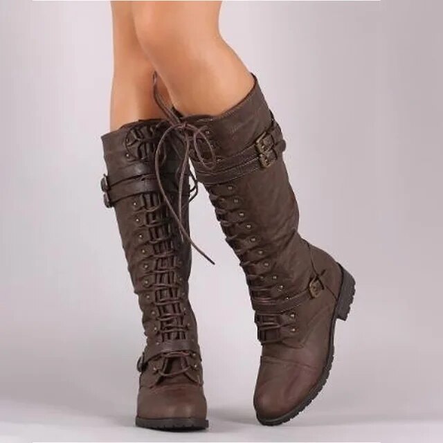 Brown retro boots with front lacing, buckled straps and rounded toes.