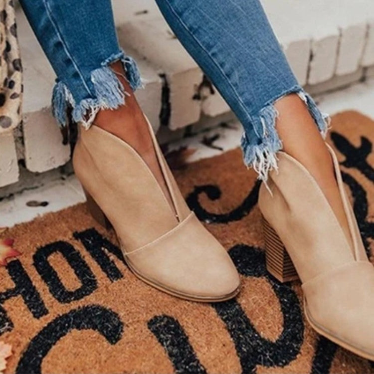Khaki ankle boots with curved front seams and block heels.