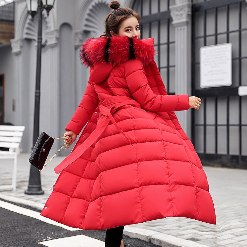Rear view of a red quilted coat with a tied belt.