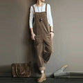 Khaki corduroy dungarees with broad straps, front pockets and turned-up hems.