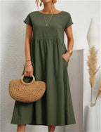 Dark green Ginovu dress with a gathered waist and side pockets.