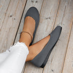 Grey round-toe flats with fine textured uppers.