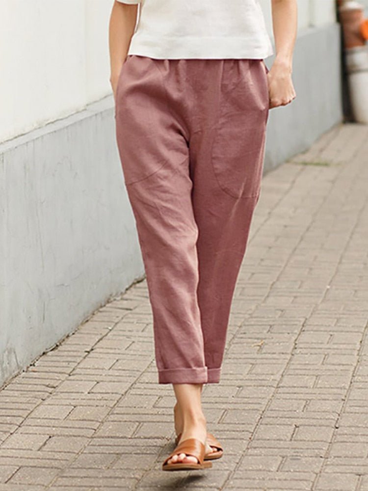 Muted red Dayanara trousers shown worn with rolled hems.